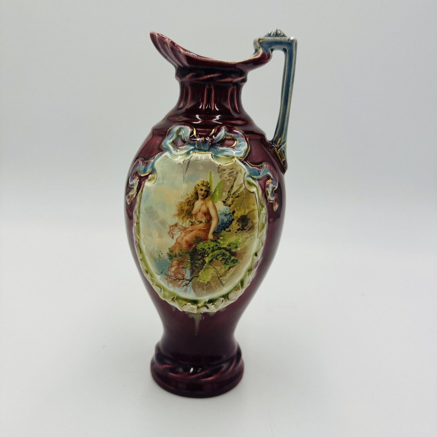 Antique Majolica red pitcher blue ribbon fairy portrait numbered 9” Porcelain