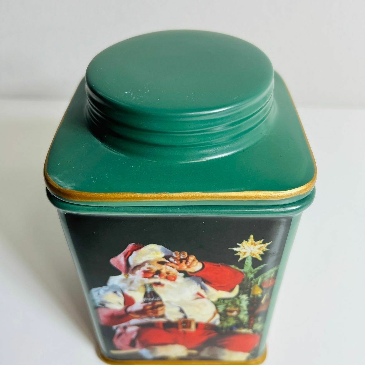 a green container with a santa clause on it