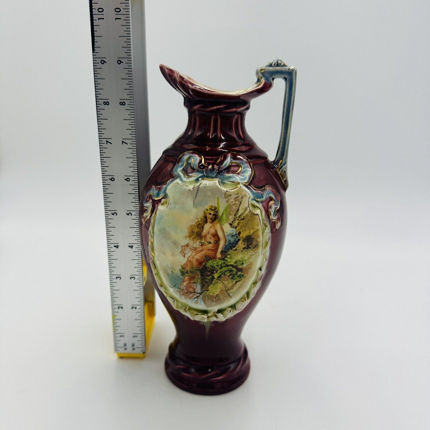 Antique Majolica red pitcher blue ribbon fairy portrait numbered 9” Porcelain